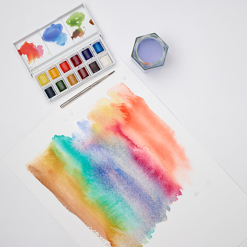 Winsor and Newton Cotman watercolour sketchers' pocket set of 13 with streaky watercolour artwork.